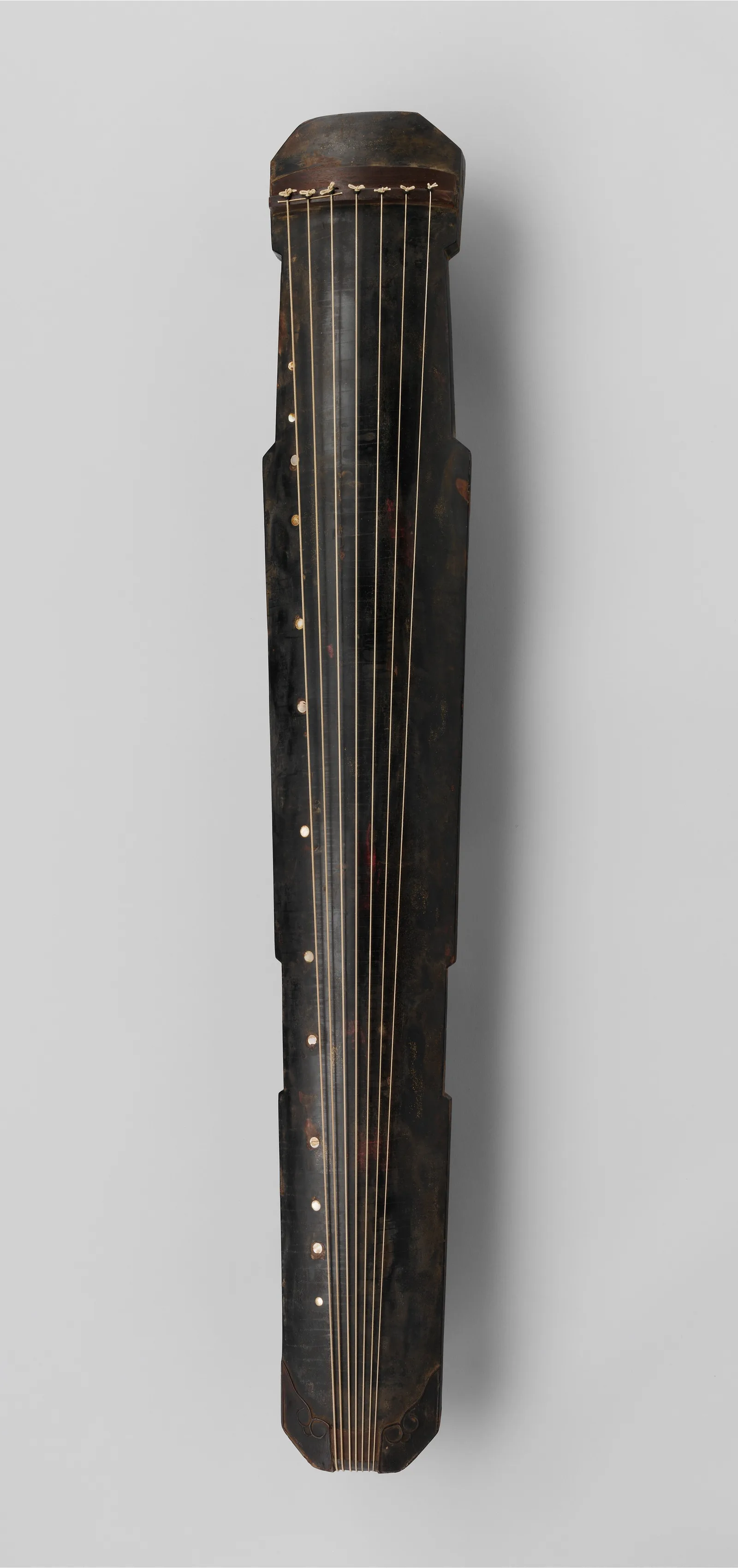 A guqin, a seven-stringed Chinese zither, photographed for a museum catalogue