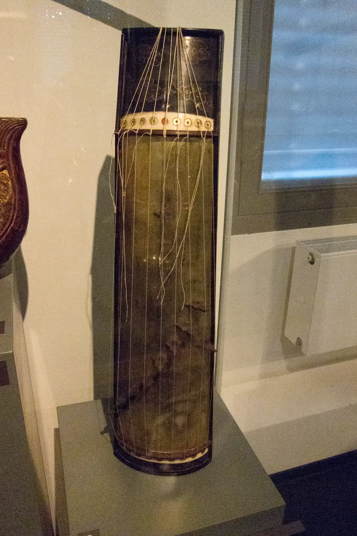 A guzheng, a Chinese plucked zither, photographed for a museum catalogue